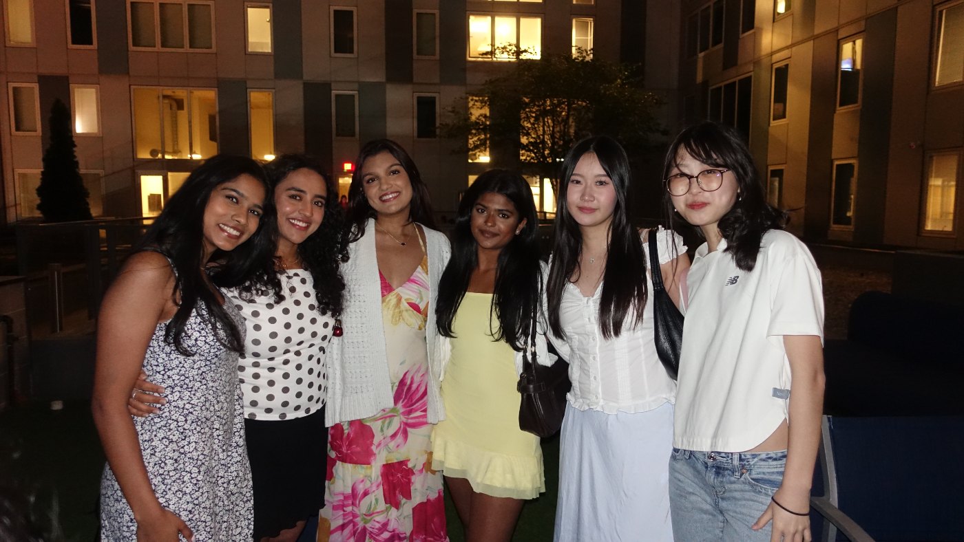 Psi Eta Mu members together outdoors at night